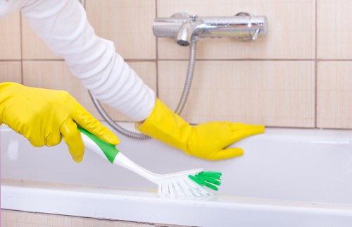 Technician handling carpet cleaning equipment with proper manual handling