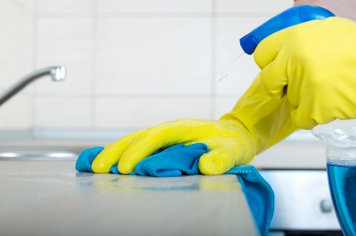 Staff member using PPE while carrying out carpet cleaning